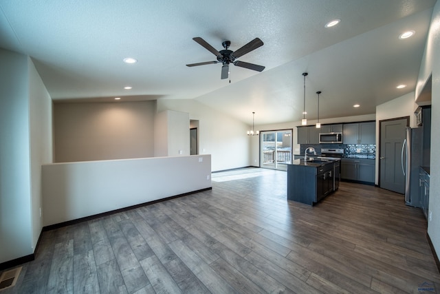 1241 Kenai Dr, Box Elder, SD 57719 - kitchen with ceiling fan, dark countertops, appliances with stainless steel finishes, open floor plan, and vaulted ceiling
