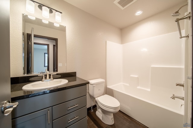 1241 Kenai Dr, Box Elder, SD 57719 - full bathroom featuring visible vents, wood finished floors, vanity, toilet, and shower / bathtub combination