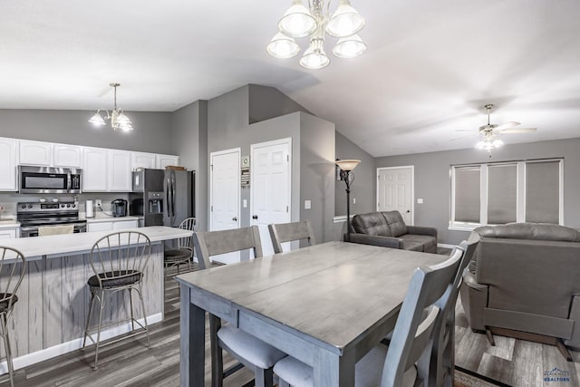 5235 Weathervane Ln, Rapid City, SD 57703 - dining area featuring dark wood finished floors, ceiling fan with notable chandelier, and lofted ceiling
