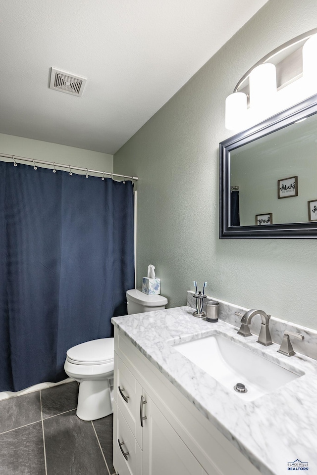 5235 Weathervane Ln, Rapid City, SD 57703 - full bathroom featuring vanity, tile patterned floors, toilet, and visible vents