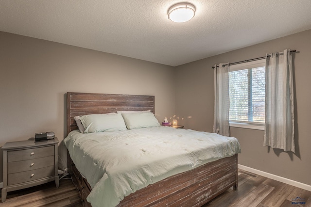 5235 Weathervane Ln, Rapid City, SD 57703 - bedroom with dark wood-type flooring, a textured ceiling, baseboards, and visible vents