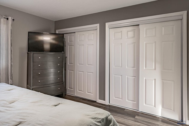 5235 Weathervane Ln, Rapid City, SD 57703 - bedroom with multiple closets and dark wood-style floors