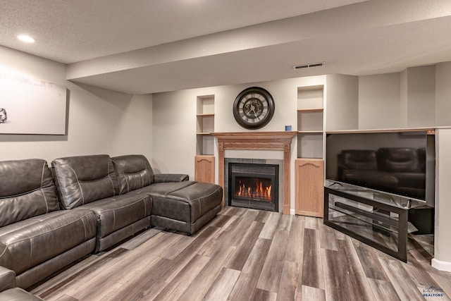 5235 Weathervane Ln, Rapid City, SD 57703 - living room with a textured ceiling, visible vents, a fireplace, wood finished floors, and recessed lighting