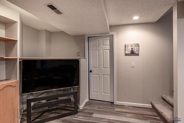 5235 Weathervane Ln, Rapid City, SD 57703 - unfurnished living room with a textured ceiling, recessed lighting, baseboards, wood finished floors, and visible vents