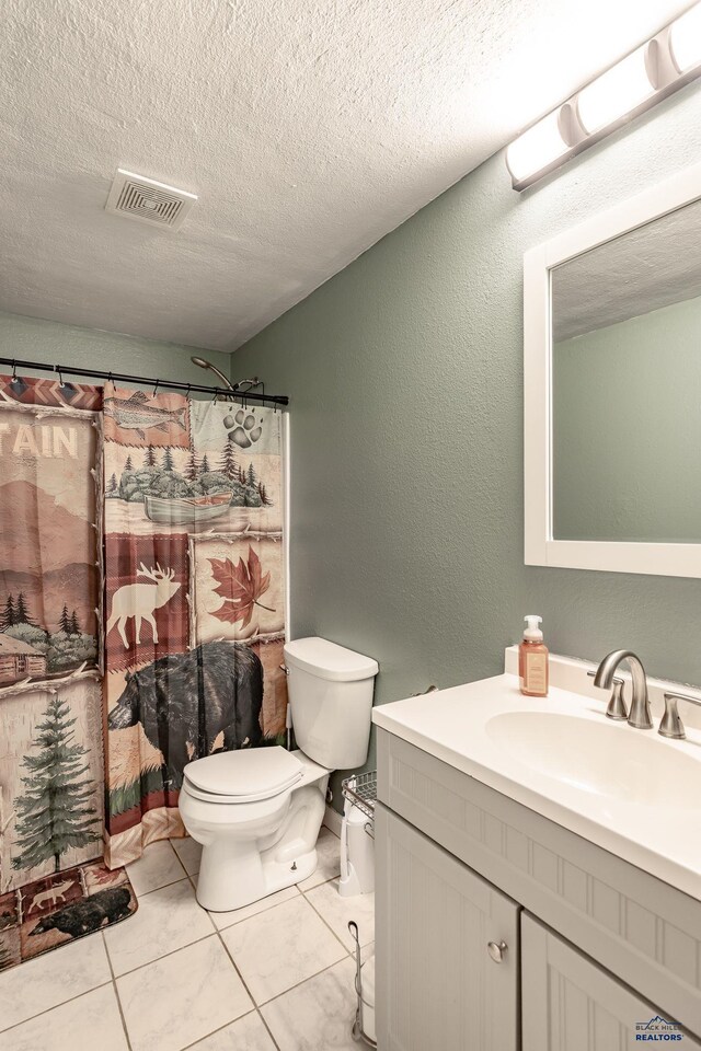 5235 Weathervane Ln, Rapid City, SD 57703 - full bathroom with visible vents, tile patterned flooring, vanity, toilet, and a textured ceiling