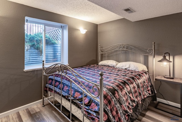 5235 Weathervane Ln, Rapid City, SD 57703 - bedroom featuring baseboards, a textured wall, and wood finished floors