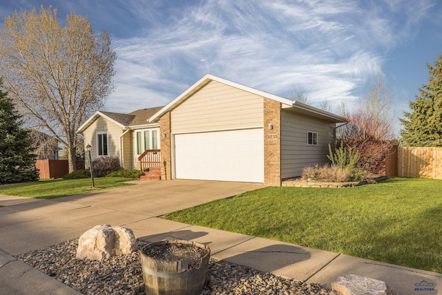5235 Weathervane Ln, Rapid City, SD 57703 - ranch-style house with a garage, a front lawn, fence, and driveway