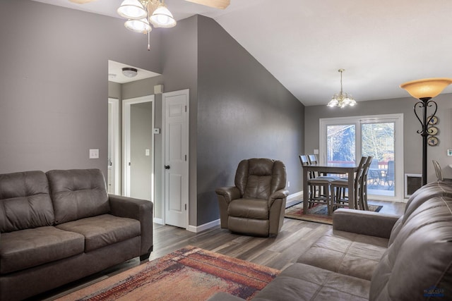 5235 Weathervane Ln, Rapid City, SD 57703 - living area with ceiling fan with notable chandelier, baseboards, vaulted ceiling, and wood finished floors