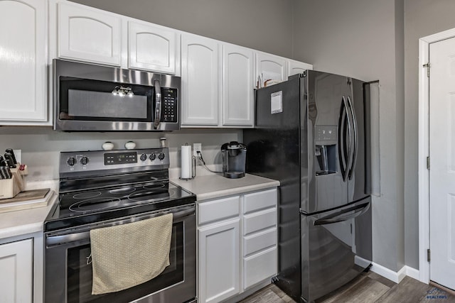 5235 Weathervane Ln, Rapid City, SD 57703 - kitchen with light countertops, white cabinetry, appliances with stainless steel finishes, and wood finished floors