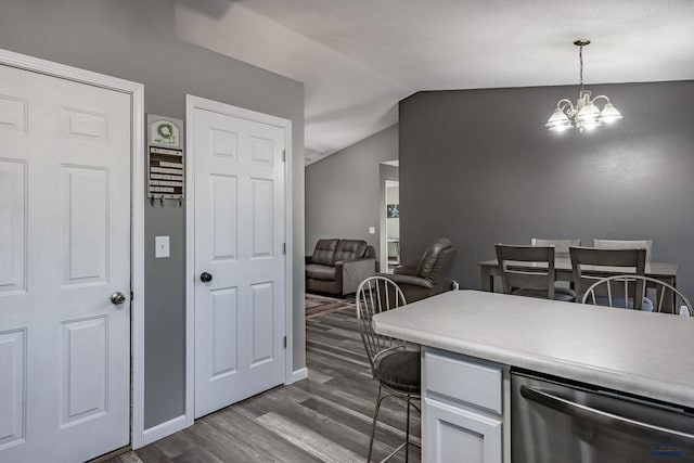 5235 Weathervane Ln, Rapid City, SD 57703 - dining area with baseboards, an inviting chandelier, vaulted ceiling, and dark wood-type flooring