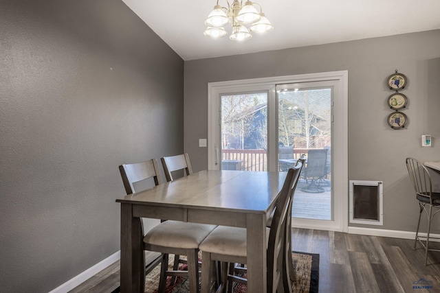 5235 Weathervane Ln, Rapid City, SD 57703 - dining room with dark wood-style flooring, baseboards, and a notable chandelier