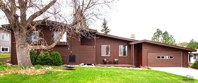 3005 Glenwood Dr, Rapid City, SD 57702 - view of front facade featuring a garage, a chimney, driveway, and a front yard