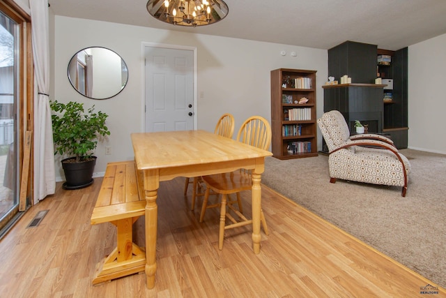 3005 Glenwood Dr, Rapid City, SD 57702 - dining area featuring light wood-style floors, baseboards, visible vents, and a notable chandelier