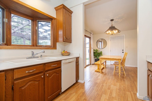 3005 Glenwood Dr, Rapid City, SD 57702 - kitchen featuring brown cabinets, a sink, dishwasher, light countertops, and light wood-style flooring