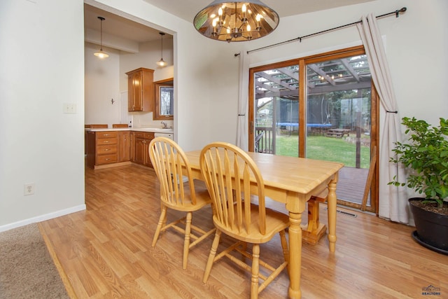 3005 Glenwood Dr, Rapid City, SD 57702 - dining area featuring baseboards, an inviting chandelier, and light wood-style flooring