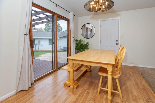 3005 Glenwood Dr, Rapid City, SD 57702 - dining space with light wood-style floors, baseboards, and a chandelier