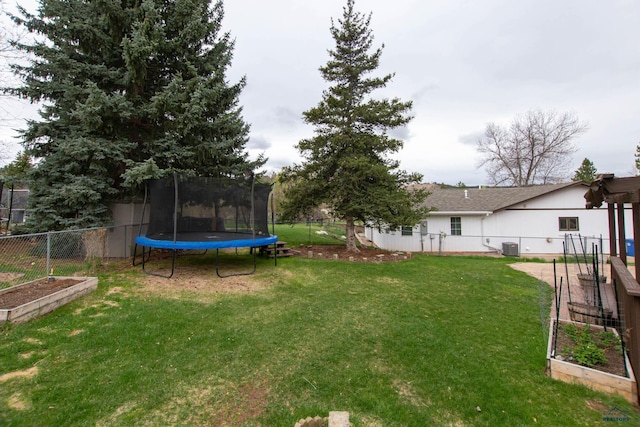 3005 Glenwood Dr, Rapid City, SD 57702 - view of yard featuring a fenced backyard, a trampoline, a garden, and central air condition unit