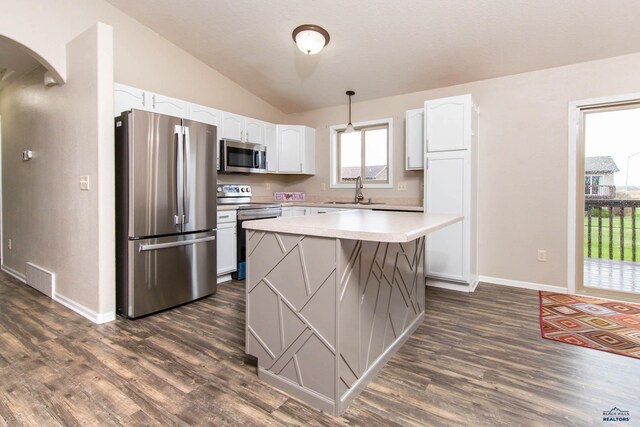 kitchen featuring white cabinets, arched walkways, appliances with stainless steel finishes, and visible vents