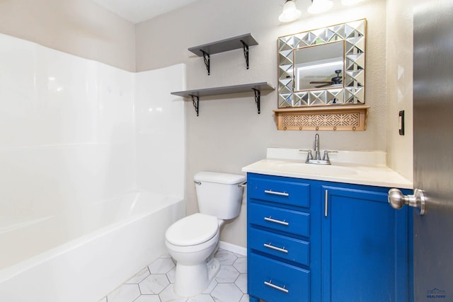 bathroom featuring vanity, tile patterned flooring, and toilet