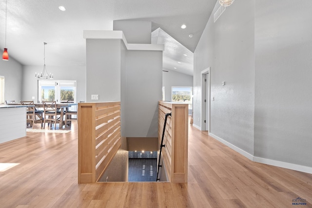 13416 Frontier Loop, Piedmont, SD 57769 - hallway with recessed lighting, a notable chandelier, lofted ceiling, and light wood-type flooring