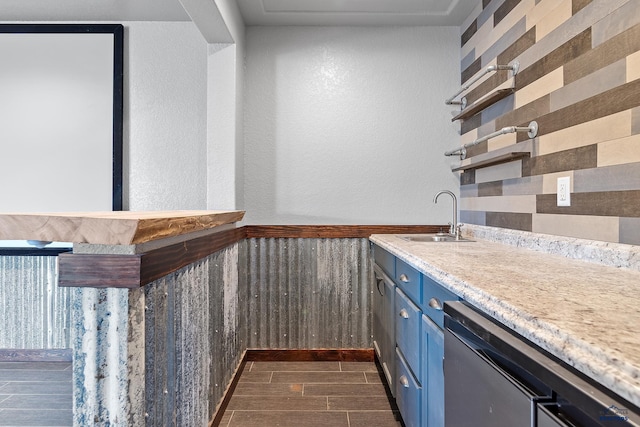 13416 Frontier Loop, Piedmont, SD 57769 - bar with wainscoting, wood finish floors, a sink, a textured wall, and indoor bar