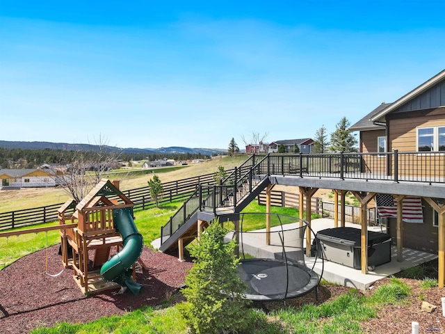 13416 Frontier Loop, Piedmont, SD 57769 - view of play area featuring fence, stairs, a trampoline, and a hot tub