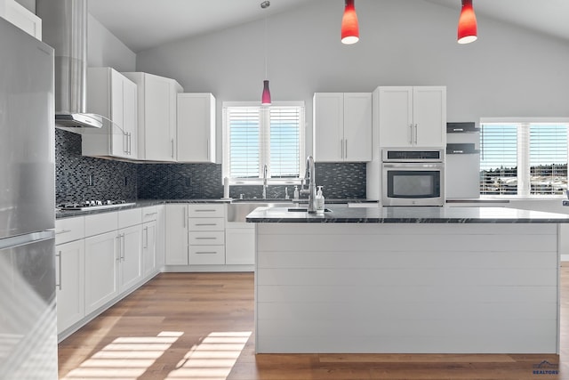 13416 Frontier Loop, Piedmont, SD 57769 - kitchen featuring a kitchen island with sink, stainless steel appliances, white cabinetry, and dark stone counters