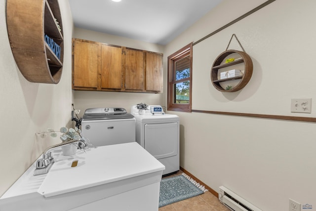 laundry area featuring washer and dryer, baseboards, a sink, cabinet space, and light tile patterned floors