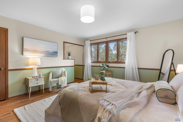 bedroom with baseboards and wood finished floors