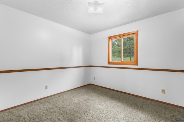 unfurnished room featuring baseboards and carpet flooring