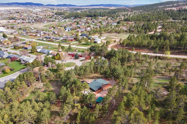 birds eye view of property featuring a mountain view, a residential view, and a forest view
