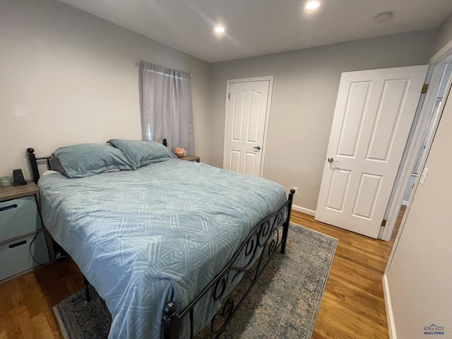 bedroom featuring recessed lighting, baseboards, and light wood-type flooring