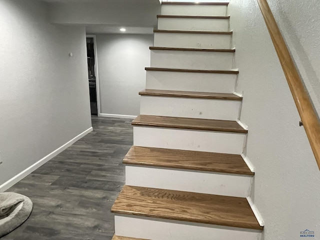 stairs featuring baseboards and wood finished floors