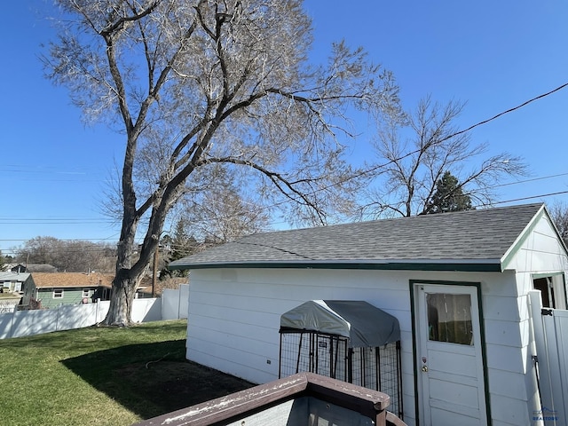 view of outbuilding featuring fence and an outdoor structure
