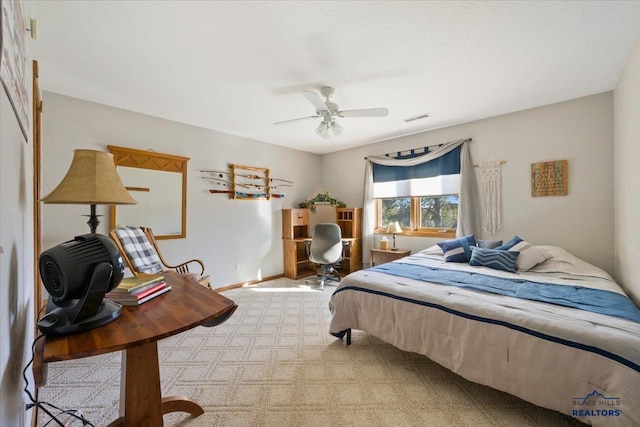 bedroom with visible vents, baseboards, ceiling fan, and light carpet