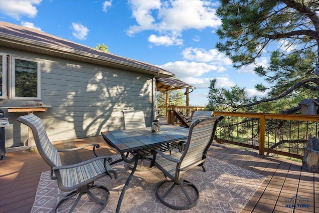 wooden deck with outdoor dining area