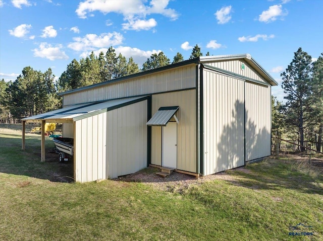 view of pole building featuring fence and a yard