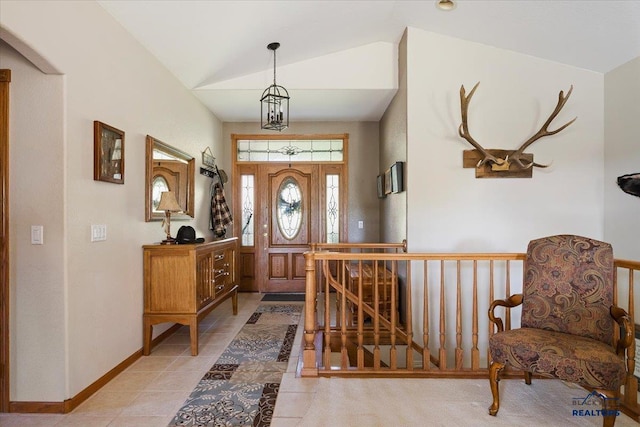 entryway featuring light tile patterned flooring and lofted ceiling