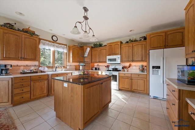 kitchen featuring decorative backsplash, light tile patterned floors, brown cabinets, and white appliances