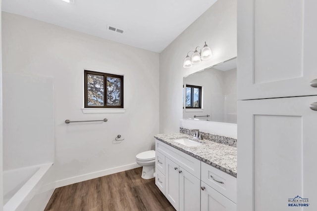 3226 W Rapid, Rapid City, SD 57702 - full bath featuring visible vents, wood finished floors, baseboards, vanity, and toilet
