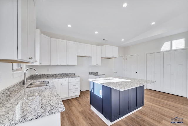 3226 W Rapid, Rapid City, SD 57702 - kitchen featuring a sink, light wood finished floors, white cabinetry, recessed lighting, and a kitchen island