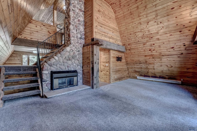 unfurnished living room with a baseboard heating unit, high vaulted ceiling, wood walls, and carpet