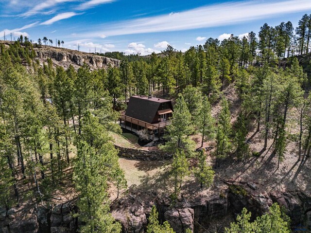 birds eye view of property with a view of trees