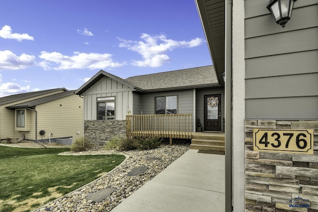 4376 Vinecliff Dr, Rapid City, SD 57701 - doorway to property with board and batten siding, roof with shingles, and stone siding
