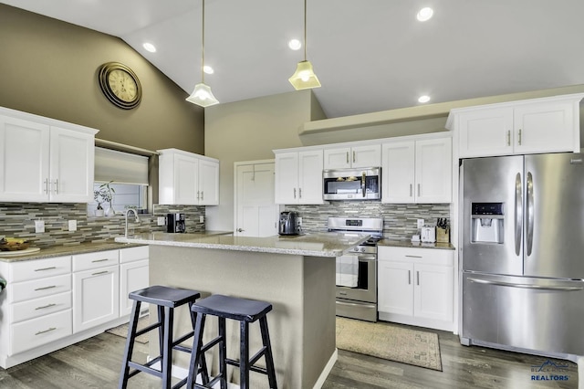 4376 Vinecliff Dr, Rapid City, SD 57701 - kitchen with a center island, decorative backsplash, appliances with stainless steel finishes, and high vaulted ceiling