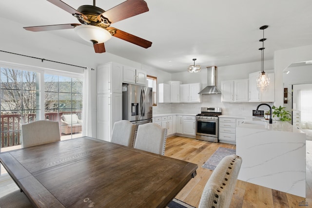 dining area featuring a ceiling fan and light wood-type flooring