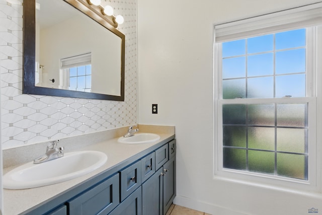 full bath with double vanity, a sink, and tasteful backsplash