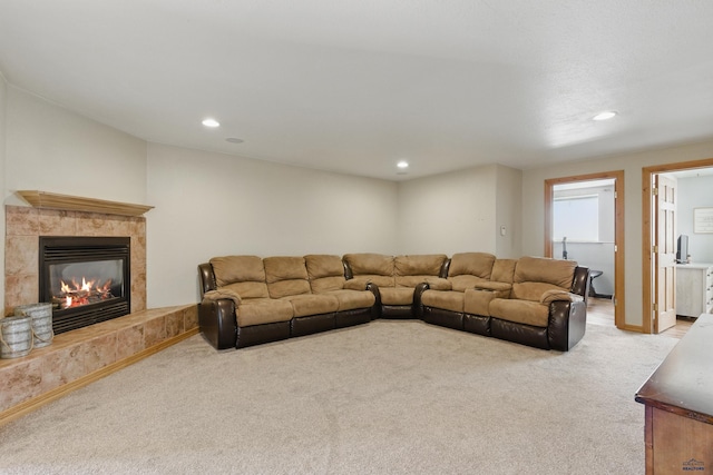 living room featuring carpet floors, a high end fireplace, and recessed lighting