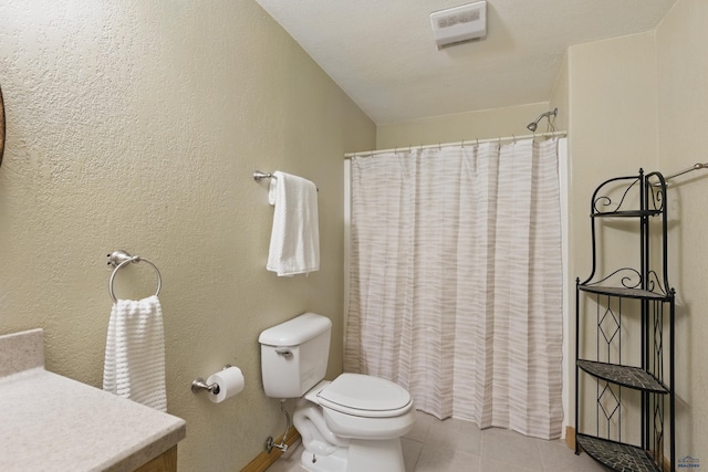 bathroom featuring vanity, toilet, tile patterned floors, baseboards, and a shower with curtain