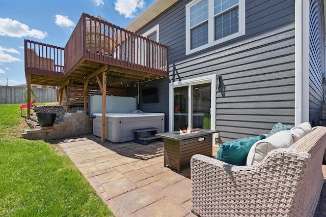 view of patio / terrace featuring fence, stairs, a hot tub, an outdoor living space with a fire pit, and a deck